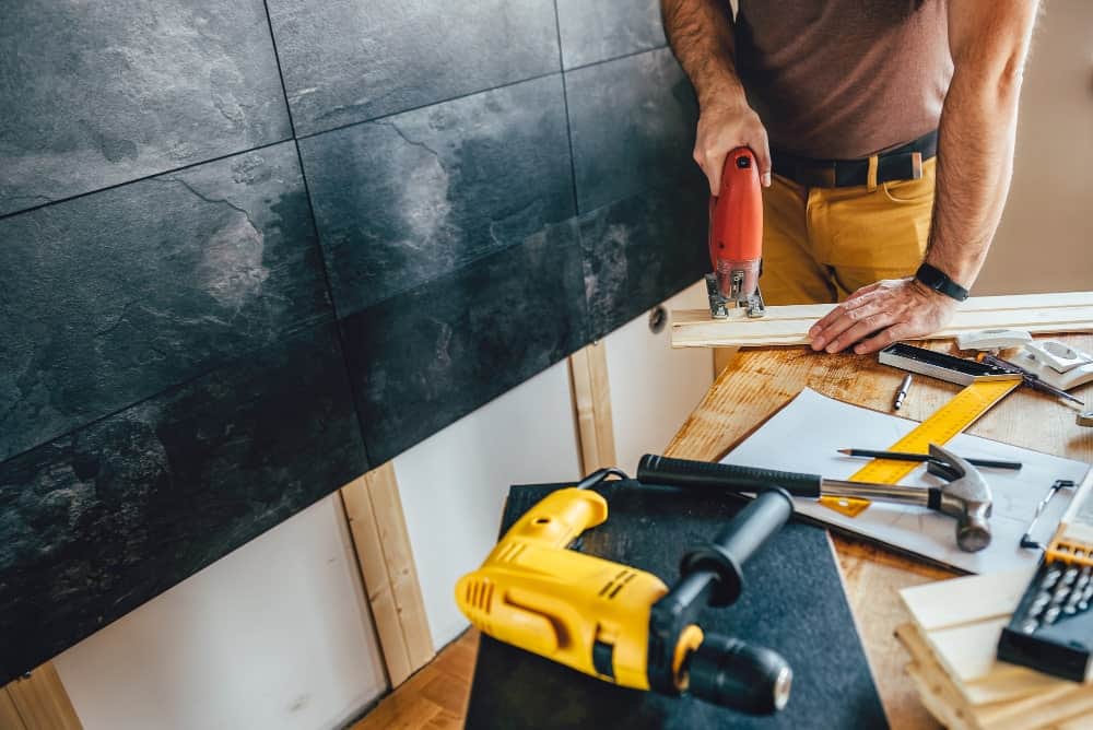 man-cutting-wood-with-electric-jigsaw