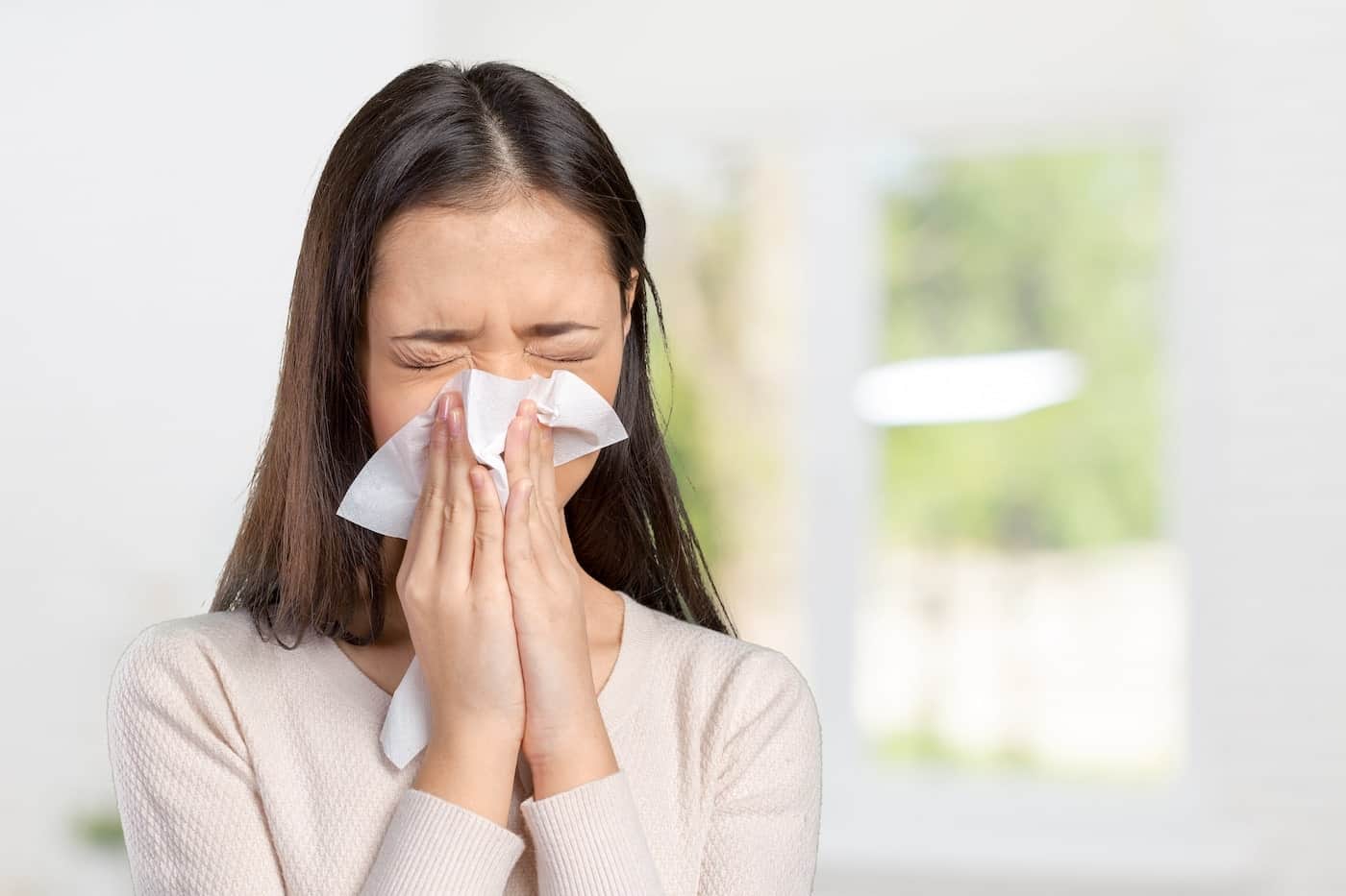 young-woman-with-handkerchief-having-cold-min