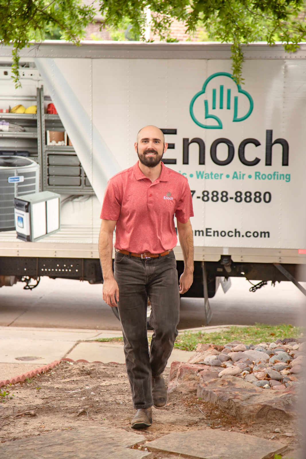 Team Enoch technician in front of a Team Enoch service van