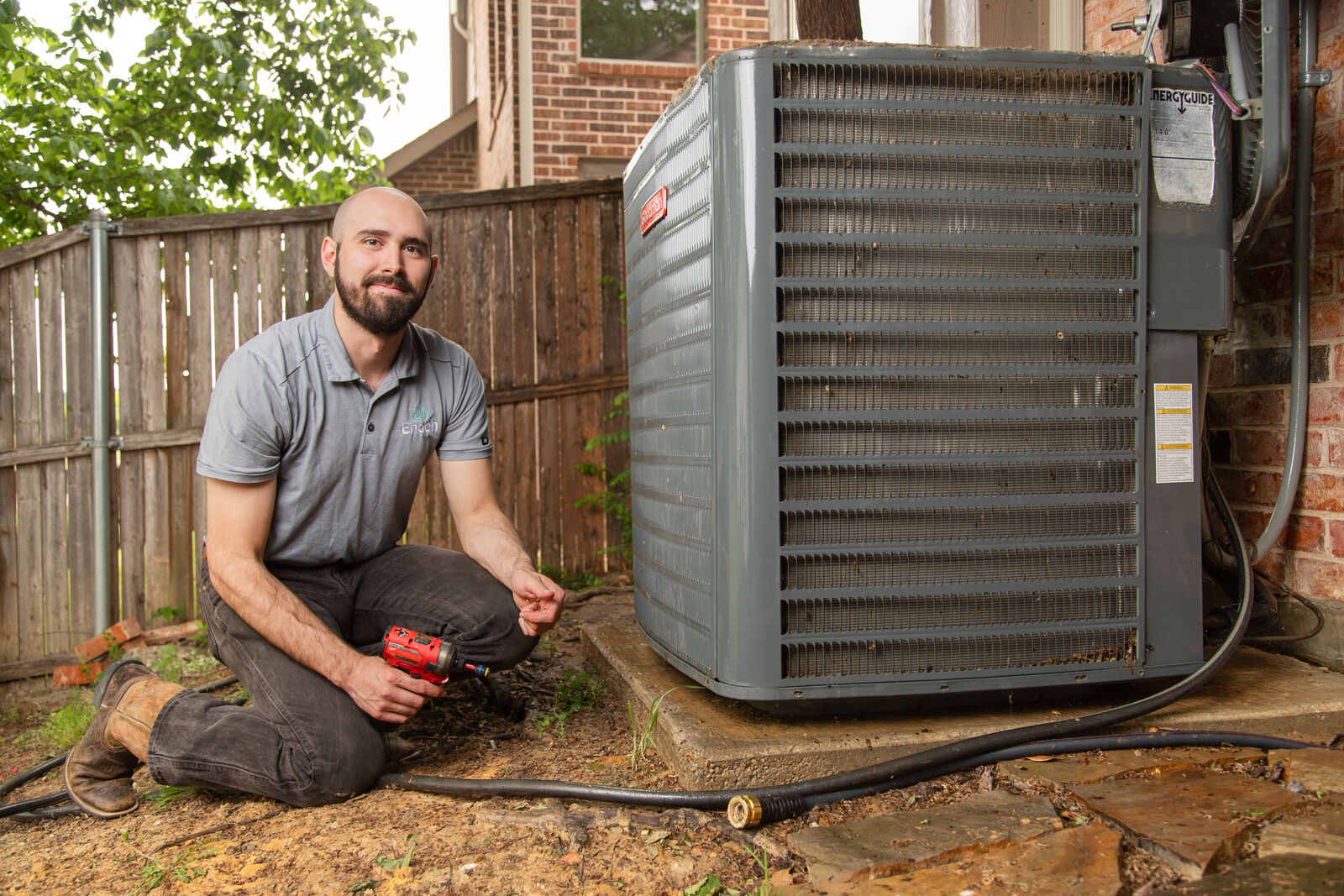 Team Enoch technician with a newly installed outdoor HVAC unit