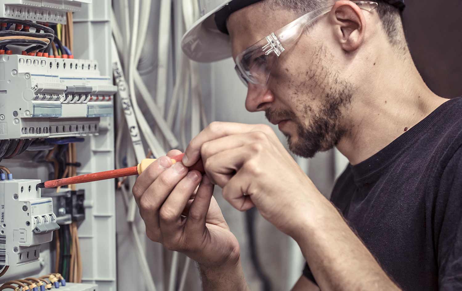 electrician working on breaker panel